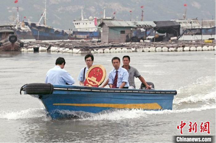 三都海上巡回法庭設(shè)立之初，法官們帶著國(guó)徽、坐著快艇，到漁排上審理、調(diào)解案件。　蕉城區(qū)法院 供圖