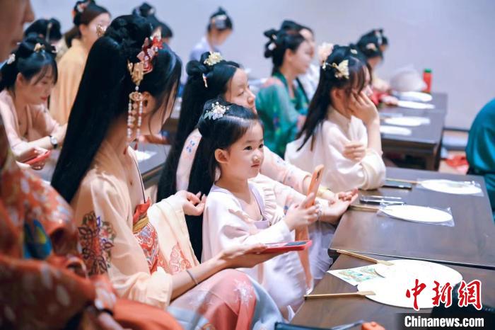 圖為游客在“宮宴”體驗傳統(tǒng)文化?！m宴供圖