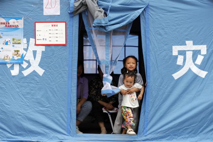 2022年6月2日，在四川省雅安市蘆山縣太平鎮(zhèn)大河村安置點(diǎn)，兩名孩子在應(yīng)急救災(zāi)帳篷里。新華社記者 沈伯韓 攝

