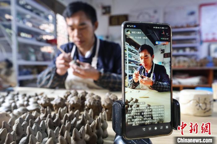 姚德波用直播方式給網(wǎng)友展示“桐梓泥哨”制作技藝?！■暮陚?攝
