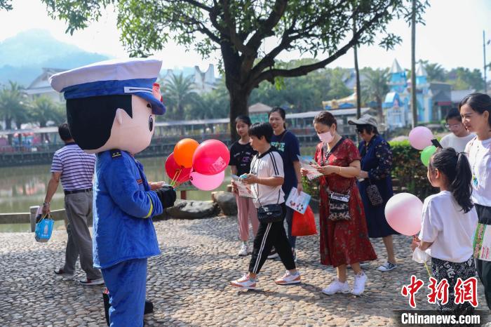 宣傳玩偶正在給游客贈(zèng)送宣傳小禮品?！±钤x 攝