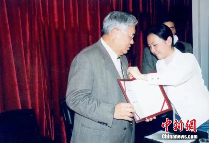 2004年3月客座教授聘任儀式上，曾永義先生(左)佩戴武漢大學(xué)?；铡｀崅饕淌诠﹫D