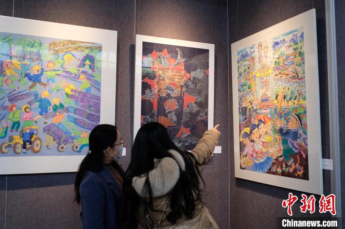 圖為前來(lái)觀展的民眾正在交流作品。　劉俊聰 攝