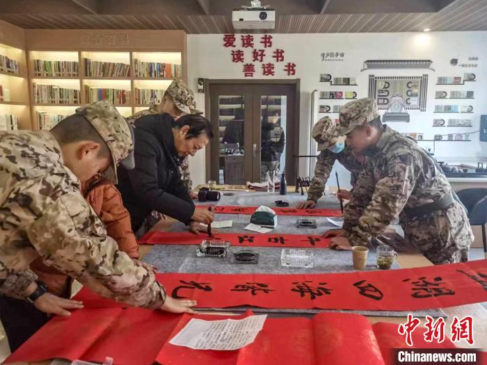 浙江衢州江山市離退休干部與武警衢州支隊江山中隊官兵共寫春聯(lián)?！”搴陮?攝