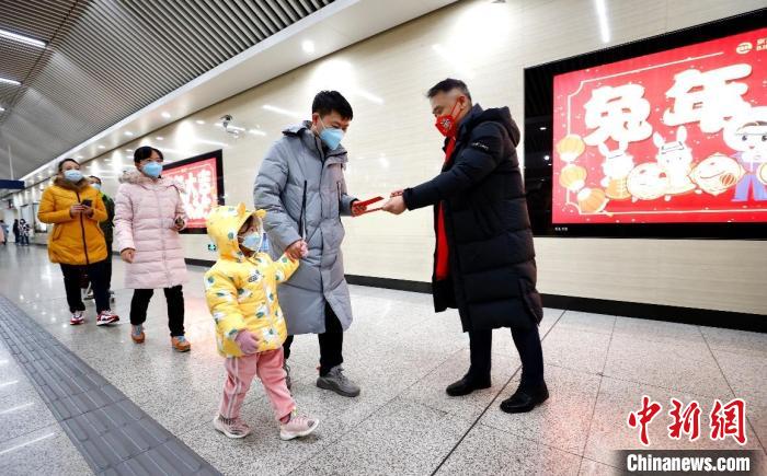 北京市朝陽(yáng)區(qū)聯(lián)動(dòng)京港地鐵在14號(hào)線(xiàn)九龍山站站廳內(nèi)為地鐵乘客派發(fā)“拜年紅包”。　<a target='_blank' href='/'>中新社</a>記者 富田 攝