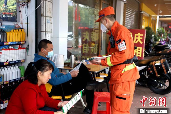 發(fā)放森林防火宣傳手冊。　司寒杰 攝