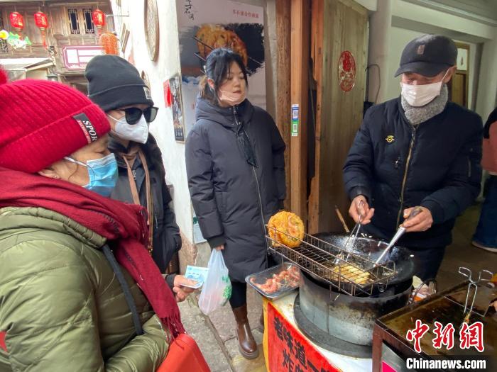 游客購(gòu)買蝦餅?！×植?攝