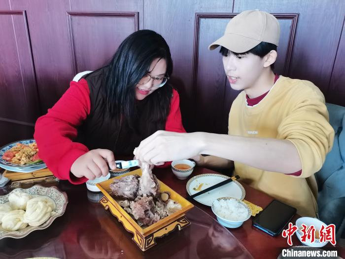 圖為內(nèi)蒙古大學(xué)學(xué)生朱拉(左一)在為臺(tái)胞青年丘秉儒(右一)科普飲食文化?！「笛碰?攝