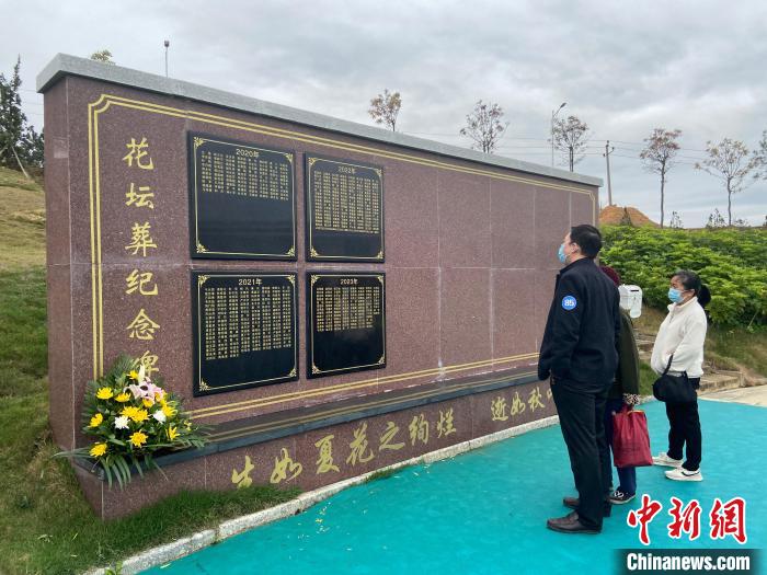 親屬參觀花壇葬紀(jì)念碑?！×譂嶇?攝