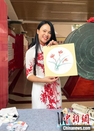 圖為越南留學(xué)生閉氏茹瓊在展示其畫作?！∨頃枣?攝