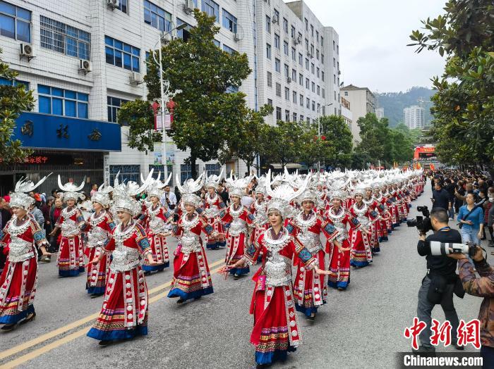上百名美麗的姑娘著節(jié)日盛裝與蘆笙隊(duì)伍進(jìn)行巡游。　付敬懿 攝