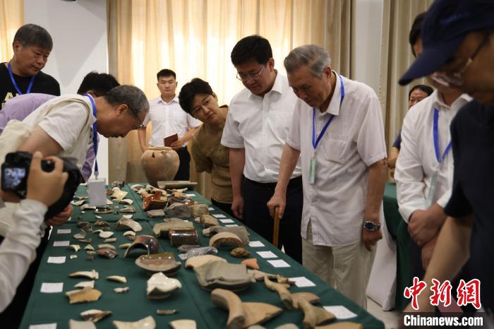 與會專家查看永濟(jì)渠故道、武城遺址出土陶、瓷碎片等。　齊紅雨 攝