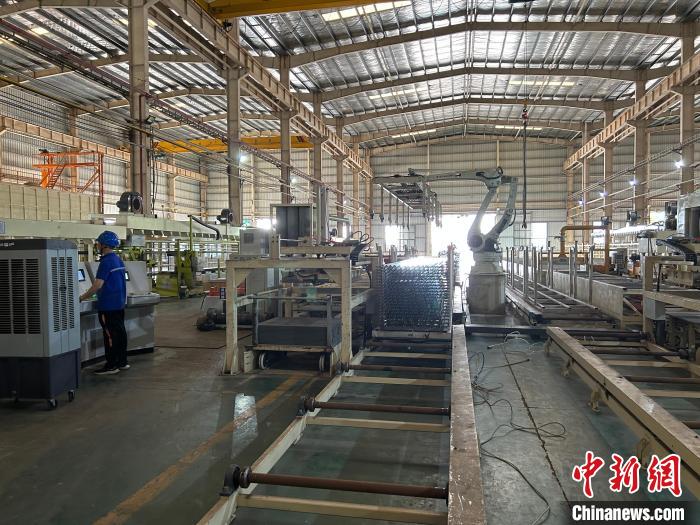圖為江西撫州安通新材科技有限公司內(nèi)，智能擠壓生產(chǎn)線正在生產(chǎn)光伏組件鋁制品?！≈飕?攝